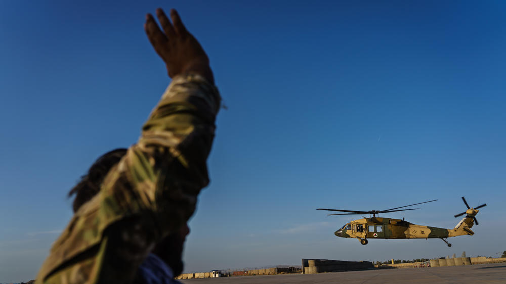 Afghan Army Capt. Rezaye Jamshid waves to a UH-60 Black Hawk aircraft taking off at Kandahar Airbase Afghanistan in May. The Taliban captured helicopters and other military equipment when they overran the Afghan military this month and reclaimed control of the country.