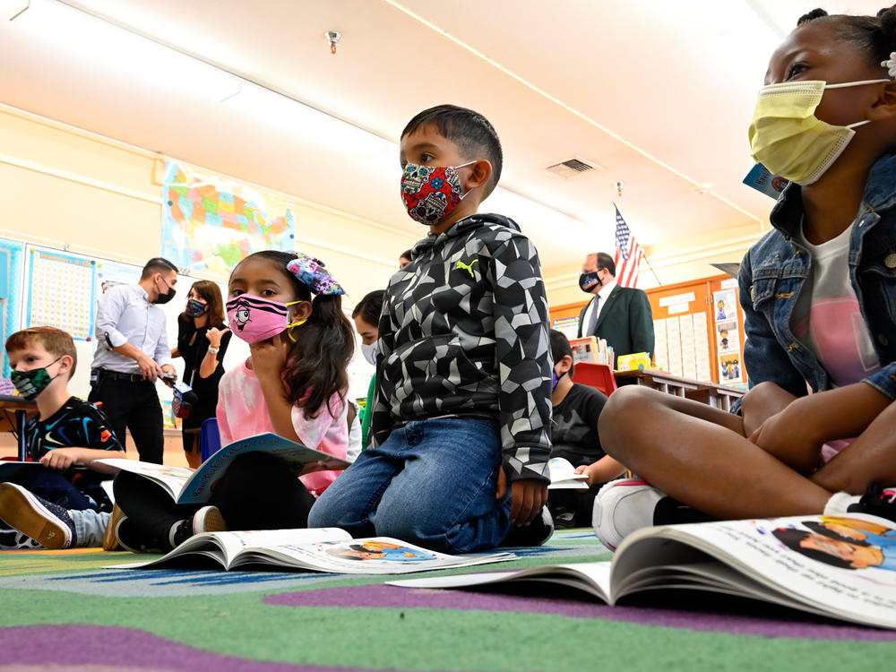 First-graders listen to the interim superintendent of the Los Angeles Unified School District, Megan Reilly, read a book at Normont Elementary School in Harbor City on Aug. 16, the first day of school.