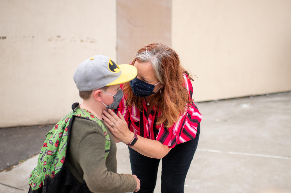 Stephanie Chenard bid her third-grader, Desmond, goodbye as he headed into his classroom last week. Screens can't replace the value of in-person interaction for schoolkids, says Saun-Toy Trotter, a psychotherapist at UCSF Benioff Children's Hospital in Oakland, Calif. 
