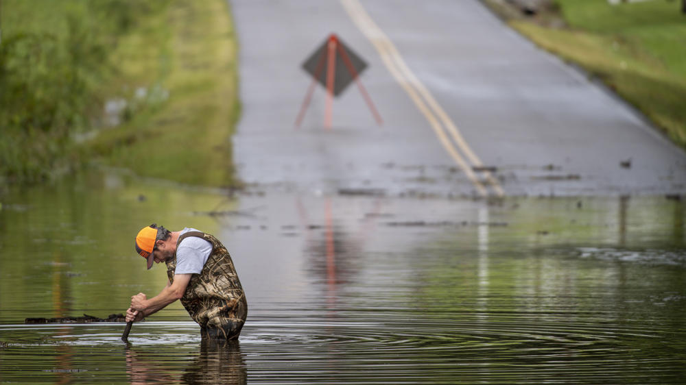 Dickson Public Works personnel check the flooding on Old Pond Lane following heavy rainfall on Saturday in Dickson, Tenn. Heavy flooding in several Middle Tennessee counties on Saturday prompted water rescues, road closures, and communications disruptions, with several people killed.