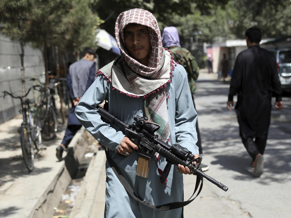 A Taliban fighter stands guard at a checkpoint in the Wazir Akbar Khan neighborhood in the city of Kabul, Afghanistan, on Sunday.