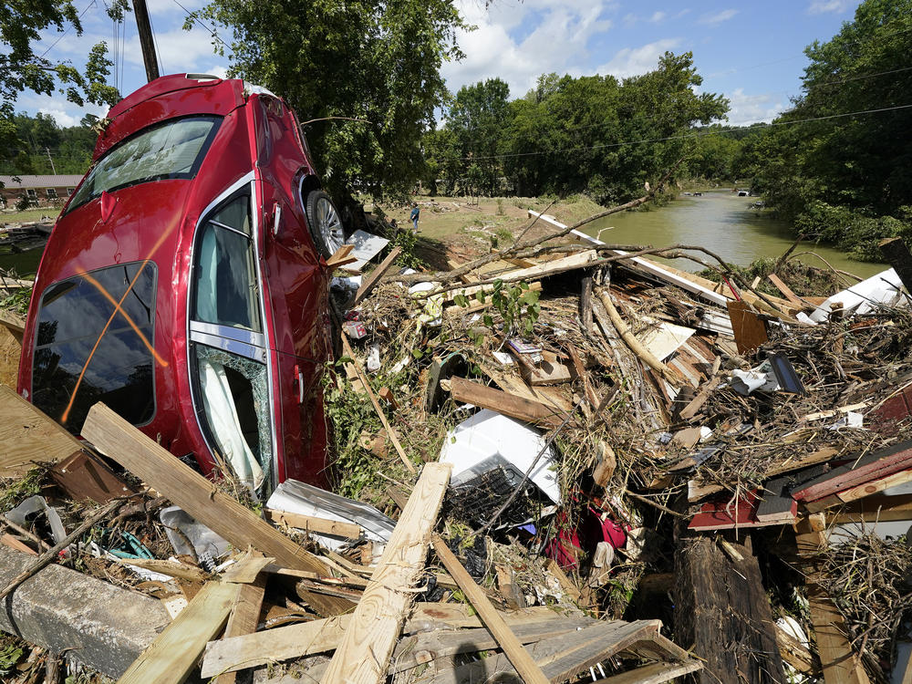 Debris could be seen piled up in Waverly, Tenn., on Sunday after heavy weekend rains caused deadly flash flooding. Climate change is driving more torrential rain around the world.