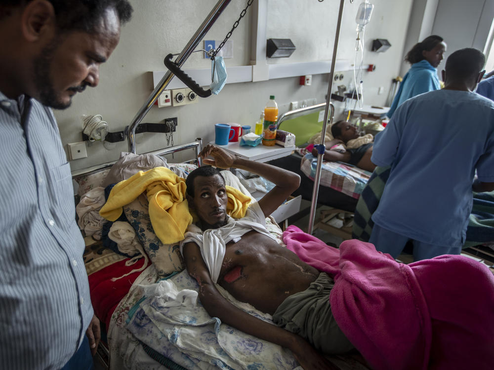 In a May 6, 2021 file photo, a farmer, Teklemariam Gebremichael, who said he was shot by Eritrean forces in Enticho six months before and is still recovering, speaks to a doctor, left, at the Ayder Referral Hospital in Mekele, in the Tigray region of northern Ethiopia. The United States on Monday imposed sanctions on Eritrea's chief of staff of the defense forces.