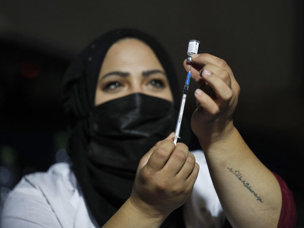 An Israeli health worker prepares to administer a third dose of the Pfizer-BioNtech Covid-19 vaccine to Jewish ultra-Orthodox people at a religious neighborhood in Jerusalem on August 19, 2021.