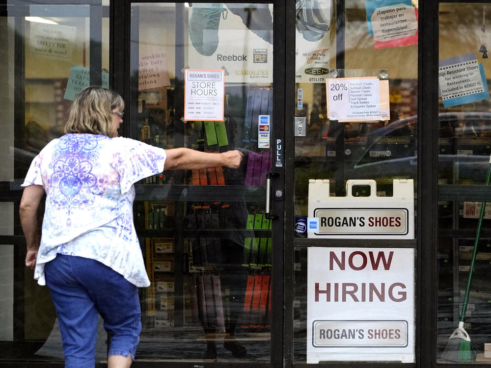 A hiring sign is displayed outside a store in Buffalo Grove, Ill., in June.