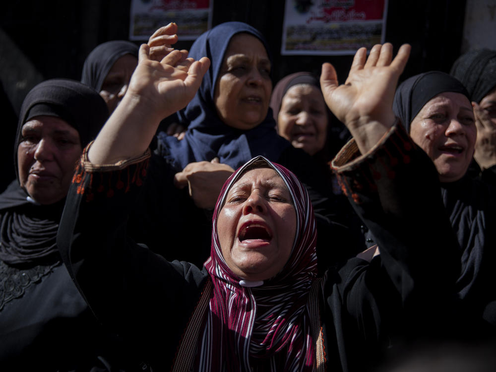Palestinian relatives mourn for Imad Hashash, 15, who was killed in clashes Tuesday with Israeli security forces. Palestinian authorities said the teenager died after being shot in the head during clashes with soldiers. Israel's military said soldiers were carrying out an arrest raid when they came under attack from nearby rooftops by Palestinians.