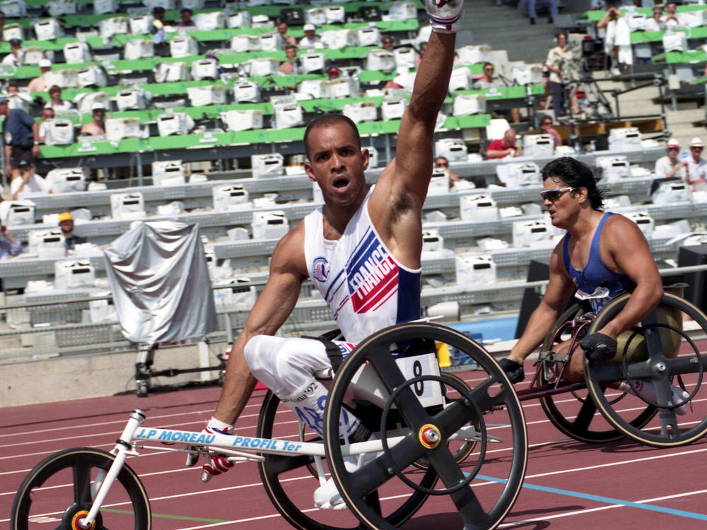 France's Claude Issorat celebrates winning the 1500m wheelchair race at the summer Paralympic Games on Aug. 2, 1992, in Barcelona.