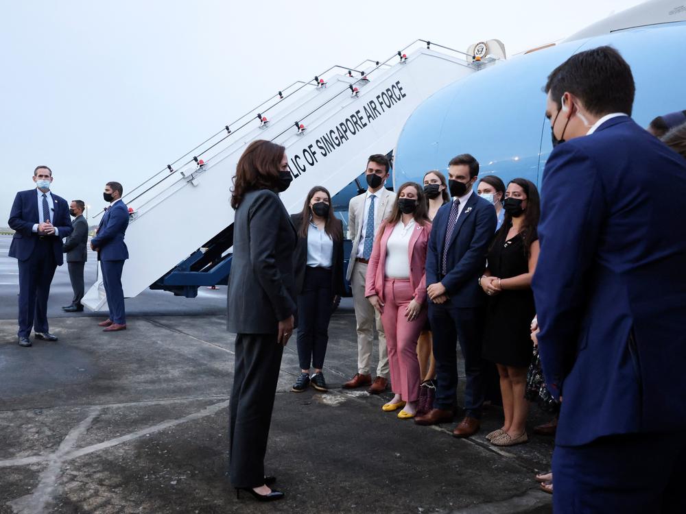 Vice President Harris (center) speaks with U.S. personnel as she departs Tuesday from Singapore on her way to Vietnam.