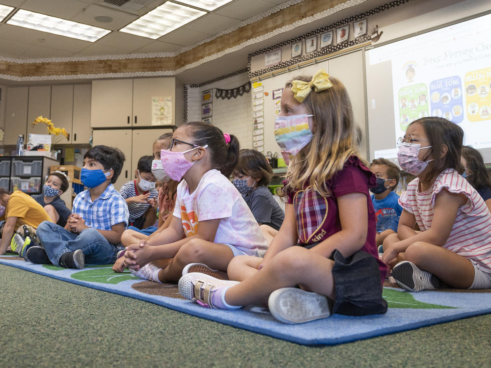 Students listen to their teacher during their first day of transitional kindergarten this month at Tustin Ranch Elementary School in Tustin, Calif.