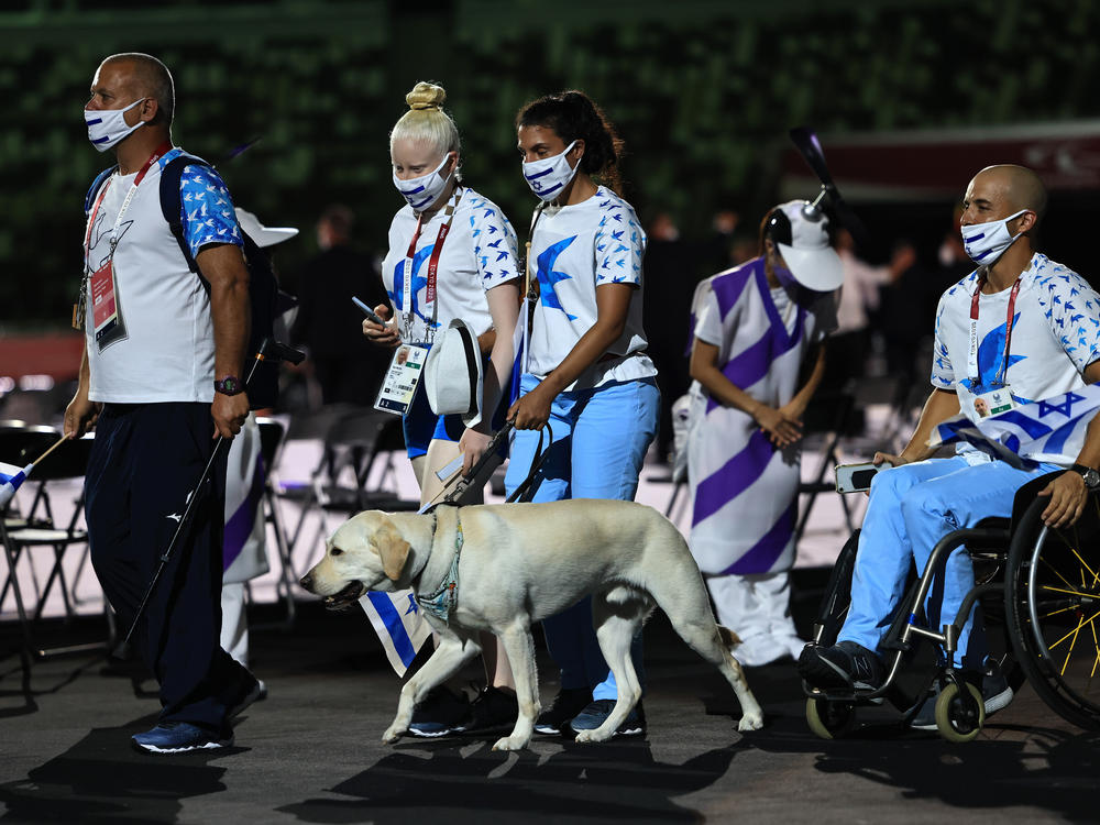 Athletes from Team Israel enter the stadium during the parade of athletes.