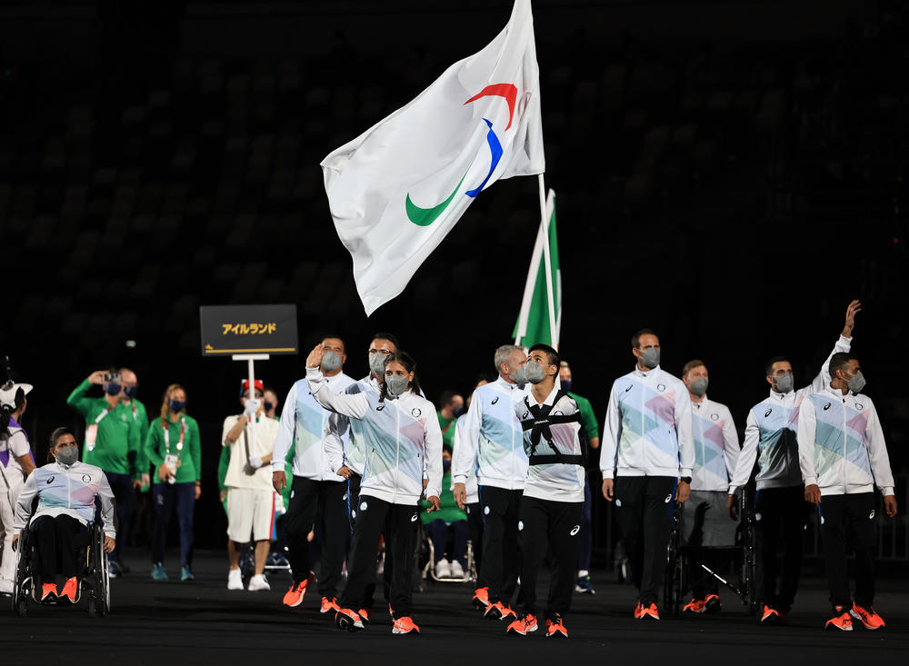Members of the Refugee Paralympic Team participate in the parade of nations during the opening ceremony.