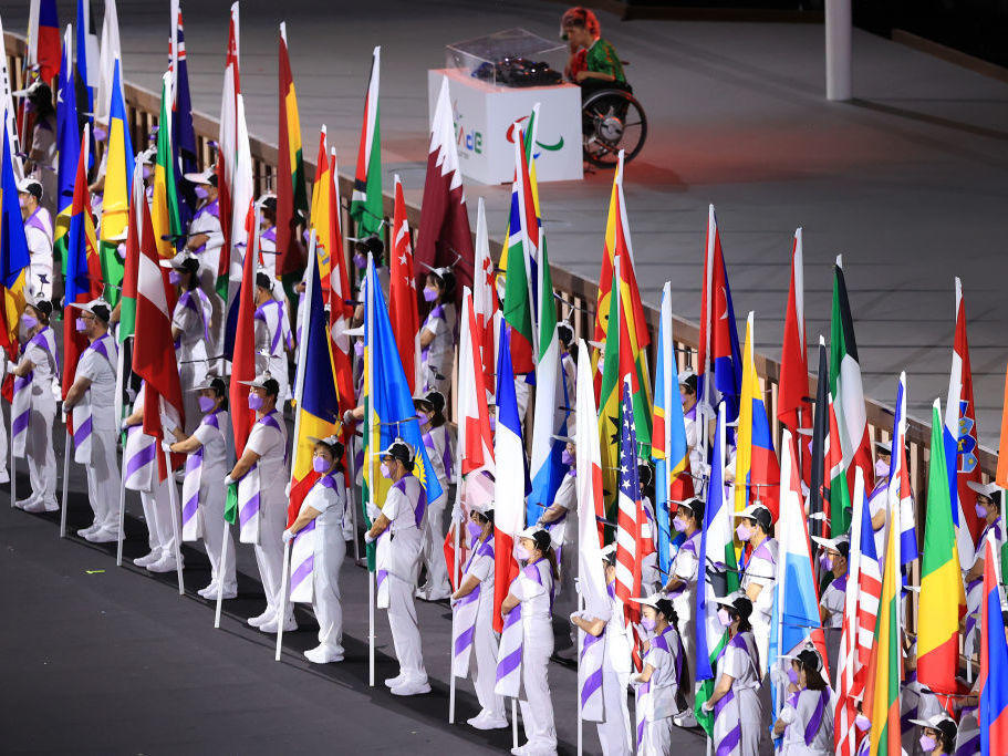 The flags of the participating nations are displayed in the parade of athletes during the opening ceremony of the Tokyo 2020 Paralympic Games on Tuesday.