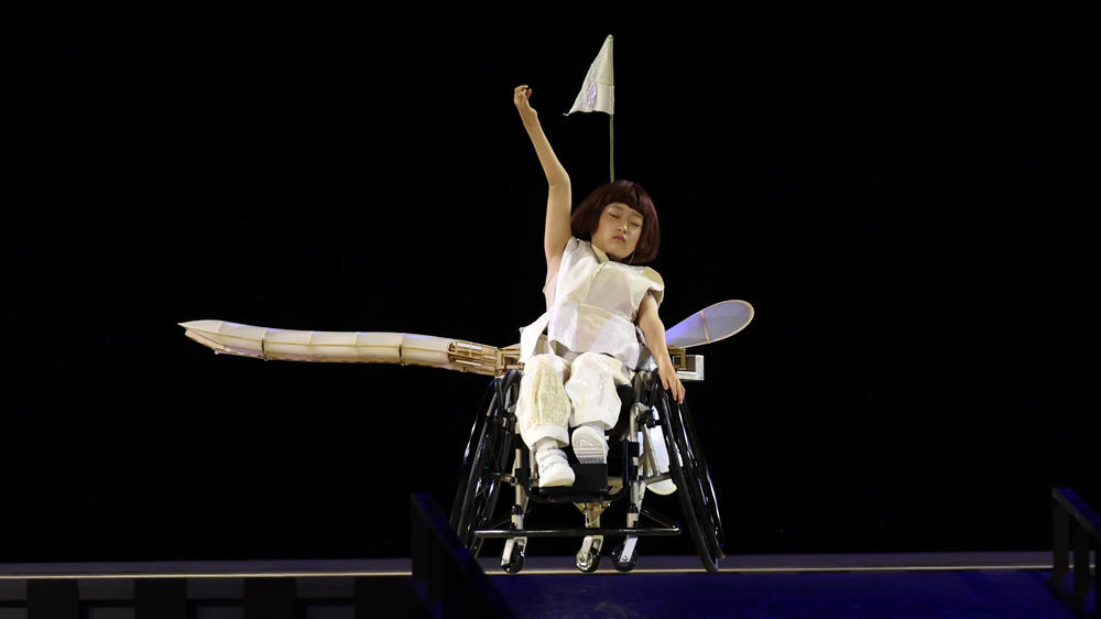 Wago Yui performs the role of a one-winged airplane that learns to symbolically fly during the opening ceremony of the Tokyo 2020 Paralympic Games.
