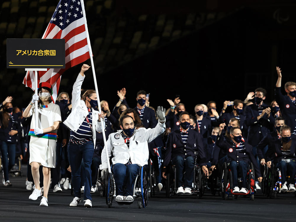 Flag bearers Melissa Stockwell and Charles Aoki of Team United States lead their delegation in the parade of athletes during the opening ceremony of the Tokyo 2020 Paralympic Games.