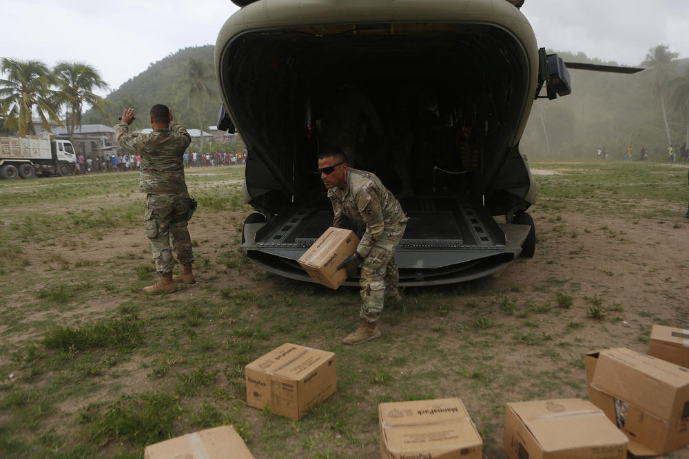 A U.S. Army helicopter unit unloaded boxes of humanitarian aid to the remote town of Baradères, Haiti, located northeast of Les Cayes on Wednesday.