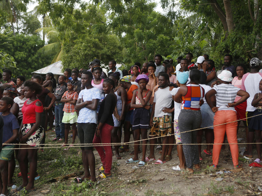 Families wait to receive humanitarian aid from a U.S. Army helicopter unit in the town of Anse-A-Veau, Haiti, on Wednesday.