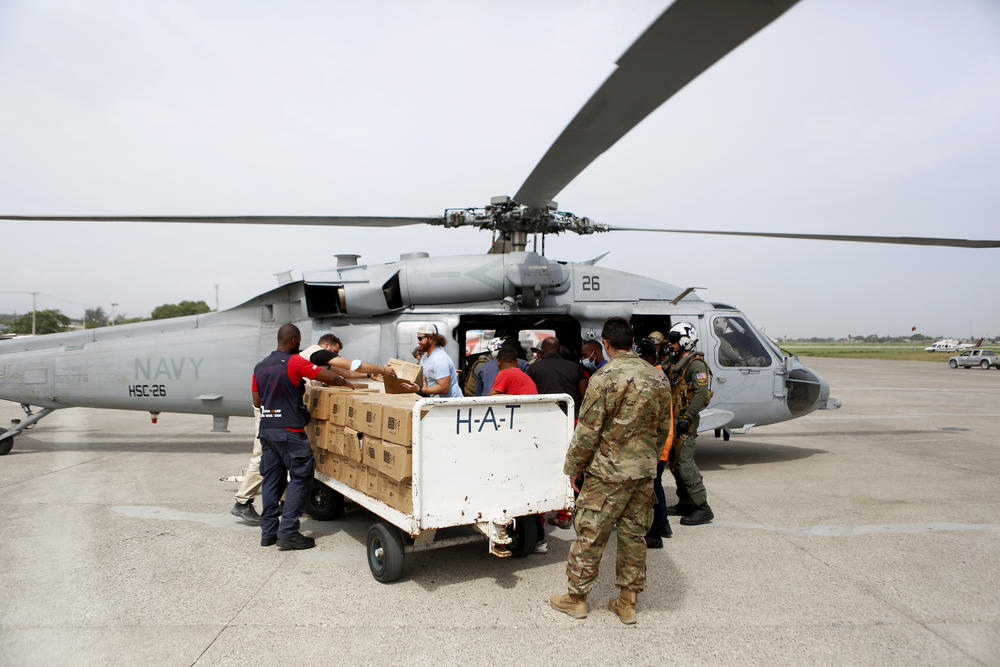 A U.S. Navy helicopter unit, USAID and other support groups prepare to deliver humanitarian aid to remote Haitian towns which were affected by the 7.2 magnitude earthquake, at the Toussaint Louverture International Airport, in Port-Au-Prince on Wednesday.