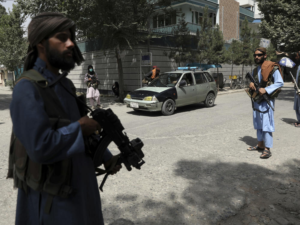 Taliban fighters stand guard at a checkpoint in the Wazir Akbar Khan neighborhood in Kabul, Afghanistan, on Wednesday.