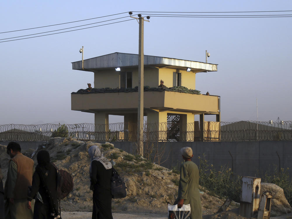 U.S soldiers stand guard at the airport tower near an evacuation control checkpoint during ongoing evacuations at Hamid Karzai International Airport, in Kabul, Afghanistan, on Wednesday. The U.S. Embassy warns Americans not to go to the airport, citing  security threats.