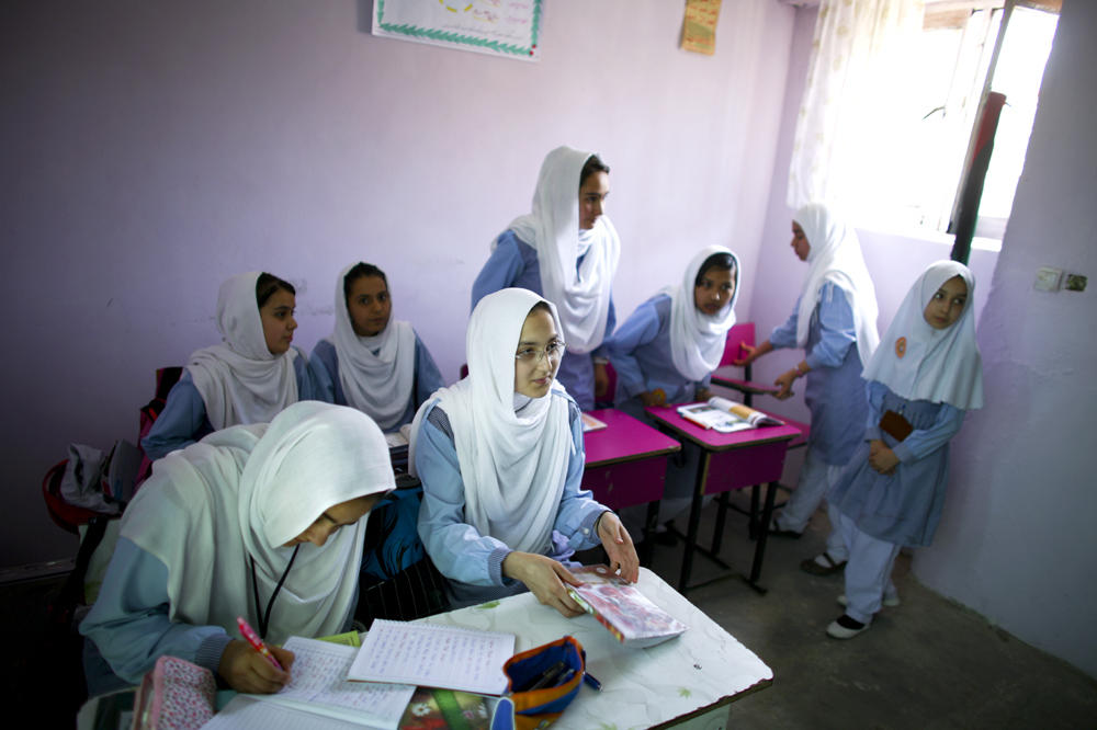 Girls study at Tanweer School in Kabul, Afghanistan, in 2015. Some nonprofit groups that focus on girls' education are scaling back their efforts now that the Taliban have again taken over the Afghan government. The militant group had previously barred girls from going to school. <em></em>