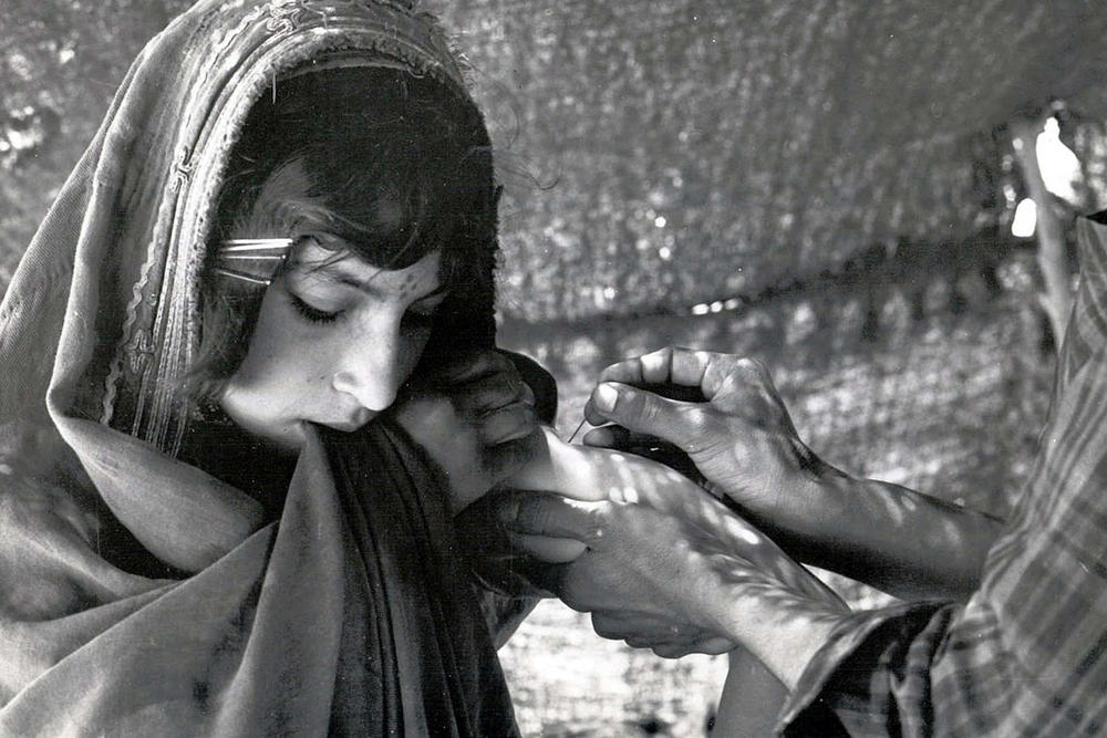 A girl in Afghanistan is vaccinated against smallpox in the 1970s, a part of the WHO's smallpox eradication campaign.
