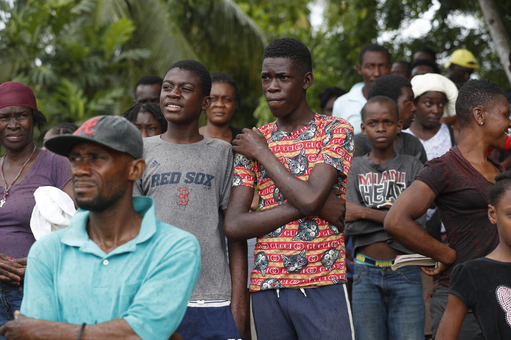 Families wait to receive humanitarian aid from a U.S. Army helicopter unit in the town of Anse-A-Veau, Haiti, on Wednesday.