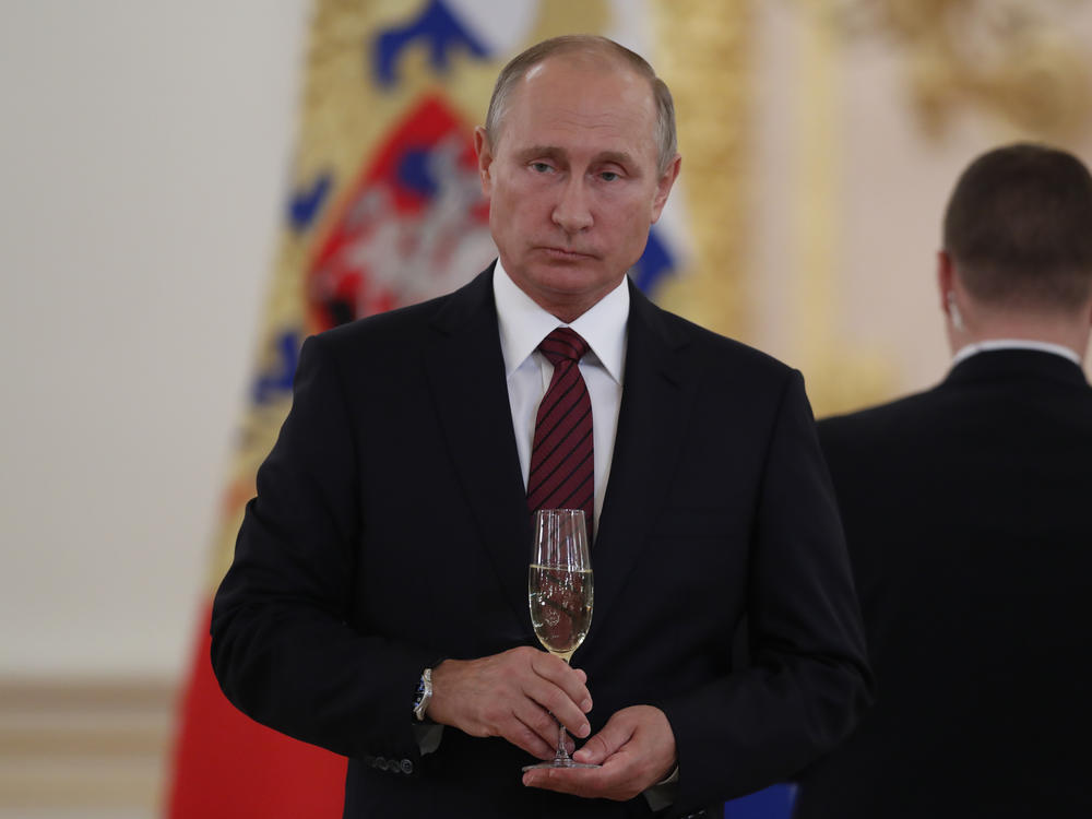 Russian President Vladimir Putin holds a glass of Soviet Champagne during a Kremlin ceremony in 2017. A new Russian law says only Russian sparkling wine may be sold in Russia as 