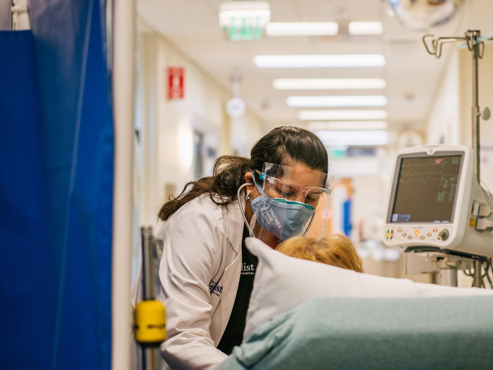 An emergency room nurse tends to a patient in a hallway last week at the Houston Methodist The Woodlands Hospital in Houston.