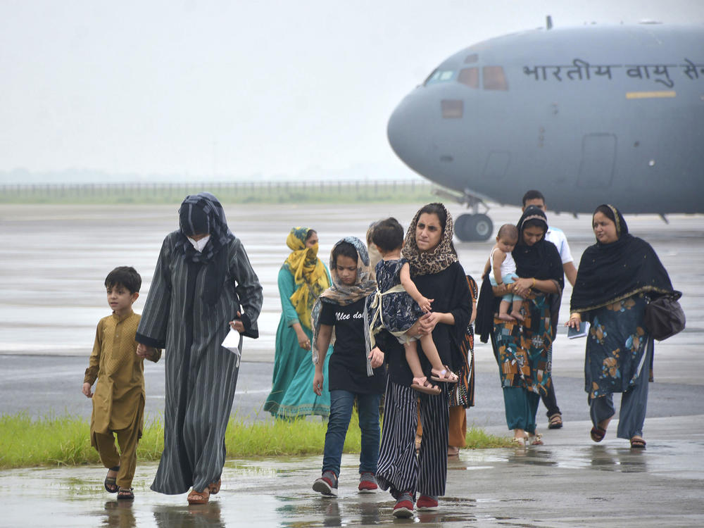 People evacuated from Kabul arrive at Hindon Air force base near New Delhi, on Aug. 22.