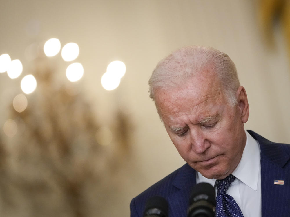 President Biden bows his head in a moment of silence Thursday as he speaks about the situation in Afghanistan from the White House's East Room.
