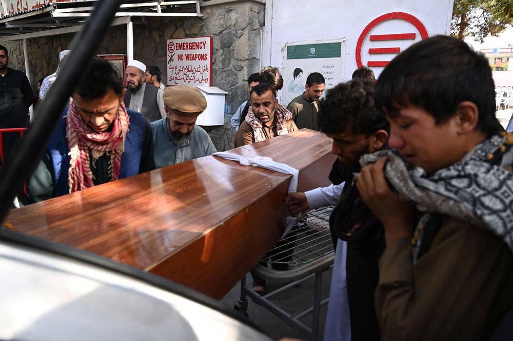 Relatives load the coffin of a victim of the Kabul attack into a car Friday at a hospital run by the Italian nongovernmental organization Emergency.