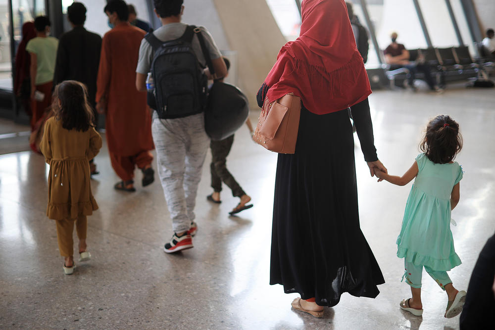 Refugees arrive at Dulles International Airport in Virginia on Friday after being evacuated from Kabul following the Taliban takeover of Afghanistan.