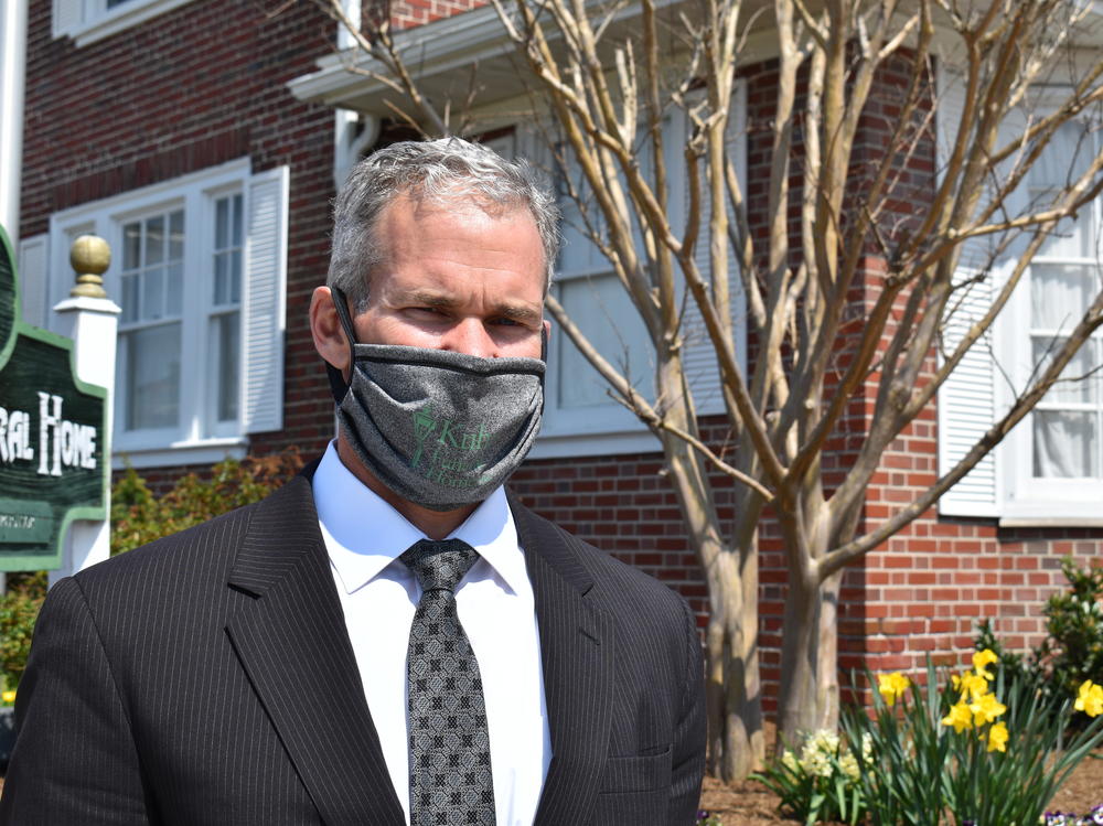 Mike Kuhn stands outside one of his funeral homes in West Reading, Pa. Kuhn says some families who lose loved ones to COVID-19 want to share that information, while others want to keep it secret.