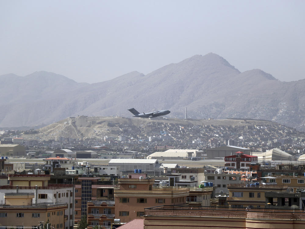 A U.S. military aircraft takes off at the Hamid Karzai International Airport in Kabul, Afghanistan, Saturday. President Biden warned another attack at the airport is 