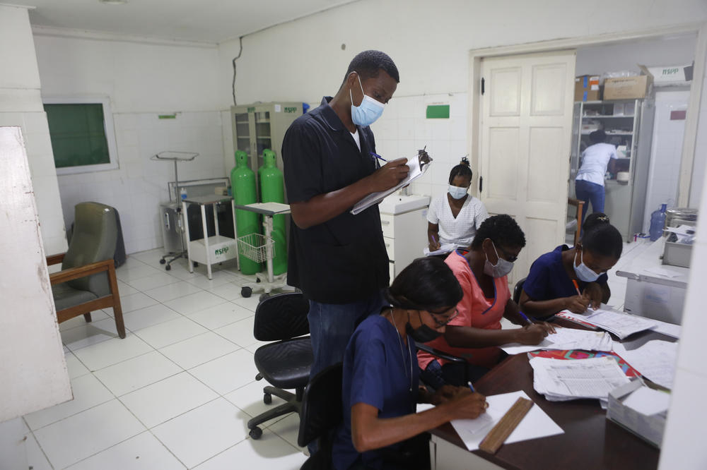 Titus talks with his staff at Immaculée Conception Hospital.