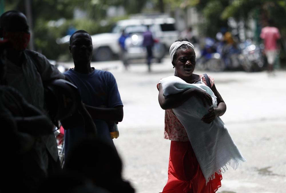 A woman and her baby at Immaculée Conception Hospital, which is still receiving people injured in the earthquake.