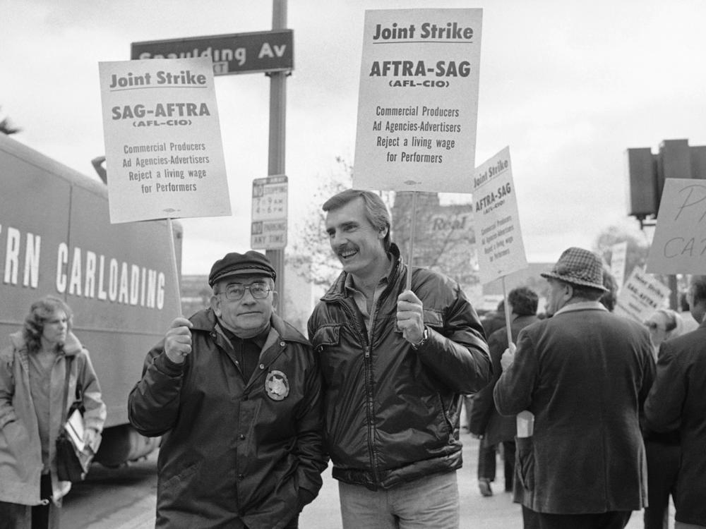 Actors Ed Asner, left and Dennis Weaver stand on a picket line in Los Angeles on Dec. 19, 1978 as some 70,000 actors and announcers who make radio and television commercials went on strike. Asner served as president of the union for two terms.