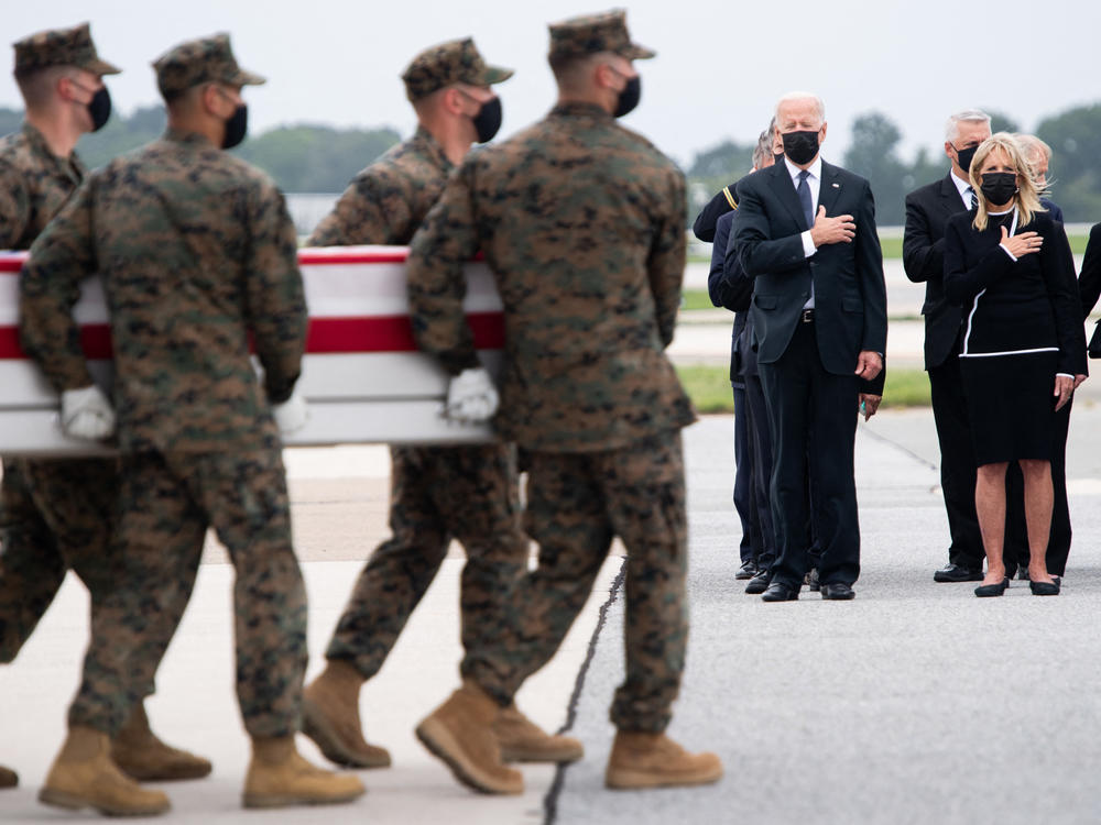 President Biden attends the dignified transfer of the remains of a fallen service member at Dover Air Force Base in Dover, Del., on Sunday.