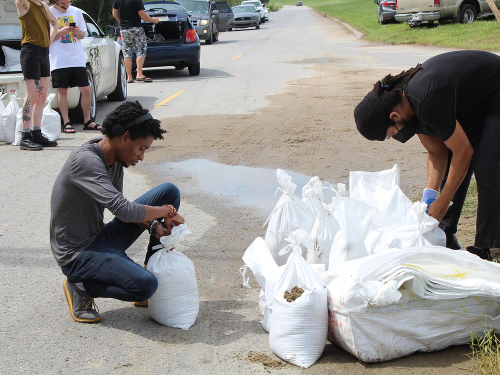 New Orleans residents Jordan Bridges and David Jones pack sandbags as they prepare to ride out the storm. Bridges described Katrina as a 