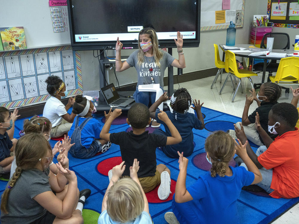 Nashville, Tenn., kindergarten teacher Amber Updegrove leads her class in a lesson this month. On Monday, the U.S. Department of Education announced an investigation into Tennessee's requirement that schools allow families to opt out of mask mandates.