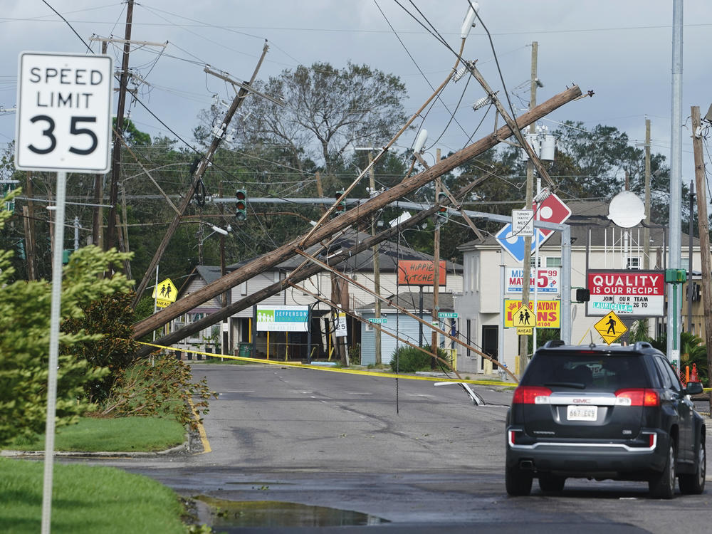 Hurricane Ida leaves downed power lines in its wake Monday in Metairie, La. The one-two punch of a natural disaster and the pandemic is complicating efforts to evacuate hospitals, seek shelter and administer COVID-19 vaccines.