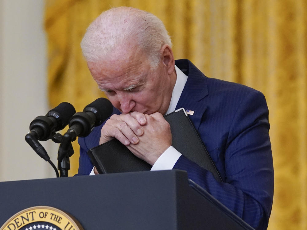 President Biden pauses, as he listens to a question about the bombings at the Kabul airport that killed 13 U.S. service members.