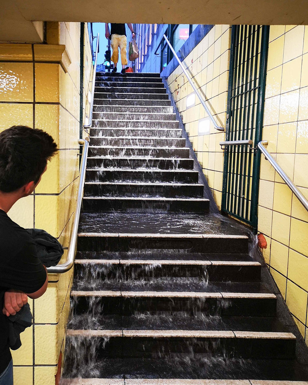 Water runs down the steps of a subway station in Berlin in 2019. Cities in the U.S. and Europe are racing to waterproof older subway systems as climate change drives more rain.