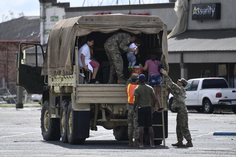 Members of the Louisiana National Guard help people in Laplace after Ida hit the region over the weekend.