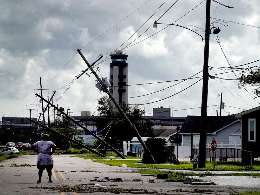 A woman surveys damage Monday from Hurricane Ida in a neighborhood in Kenner, La. The storm was fueled by abnormally warm water in the Gulf of Mexico.