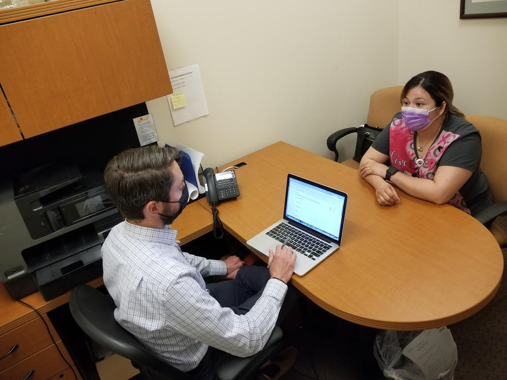 Attorney Marc Scanlon meets with client Kimberly Ledezma at Salud Family Health Centers' clinic in Commerce City, Colo. Every day in this Denver suburb, four lawyers join the clinic's physicians, psychiatrists and social workers to consult on cases, as part of the clinic's philosophy that mending legal ills is as important for health as diet and exercise.