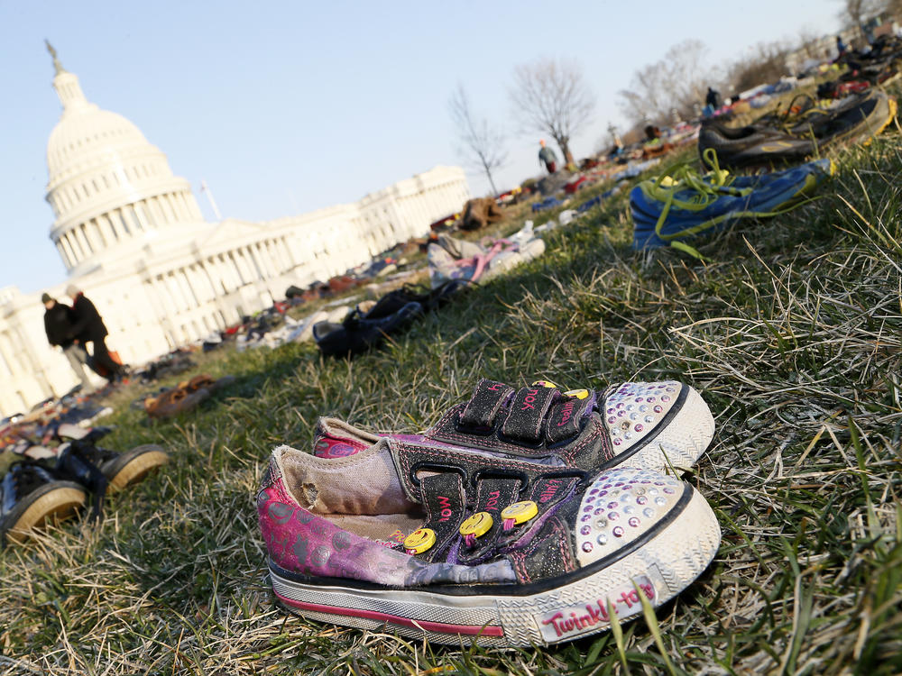 Thousands of empty empty pairs of shoes for every child killed by guns in the U.S. since Sandy Hook cover the southeast lawn of U.S. Capitol on March 13, 2018, in Washington, D.C.