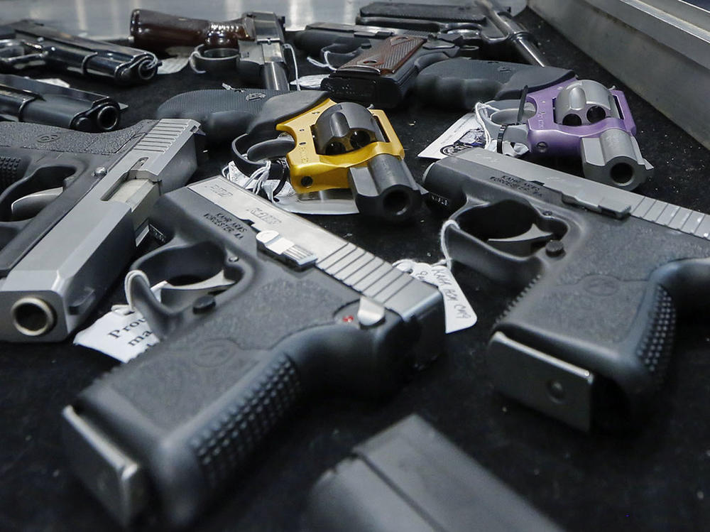Handguns are displayed on a vendor's table at a gun show in Albany, N.Y., on Jan. 26, 2013.