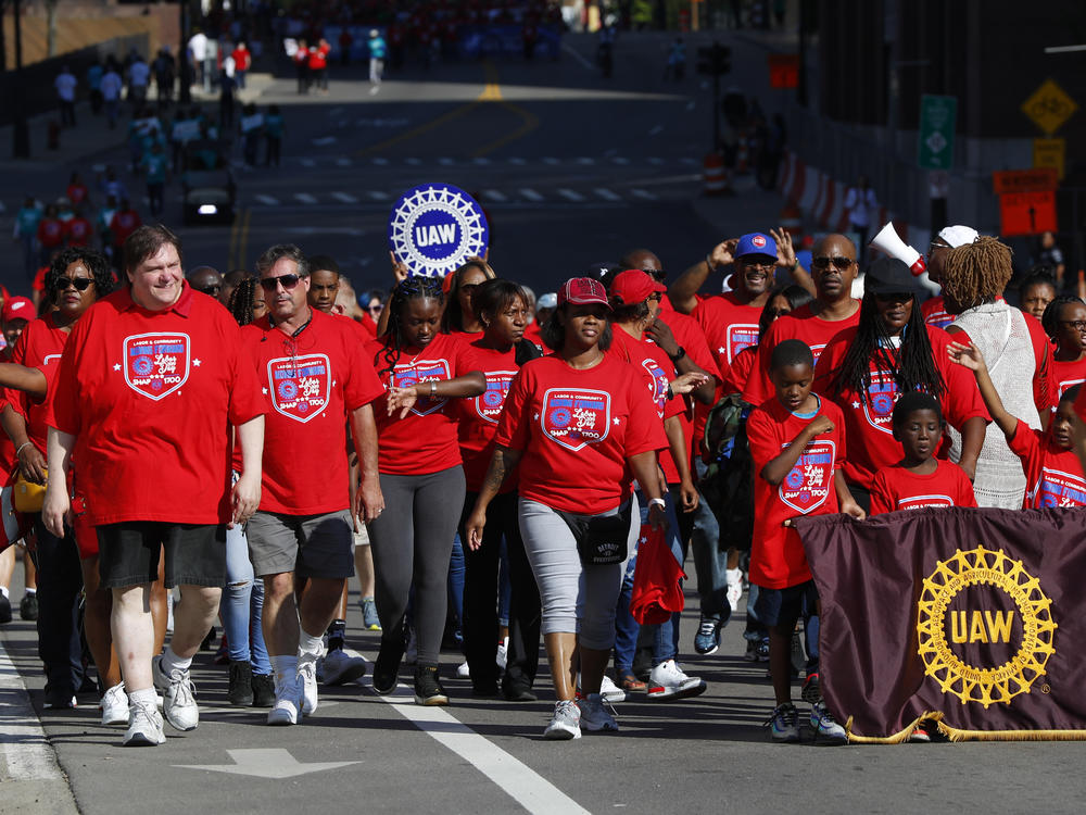 United Auto Workers members walk in the Labor Day parade' in Detroit, Monday, Sept. 2, 2019.