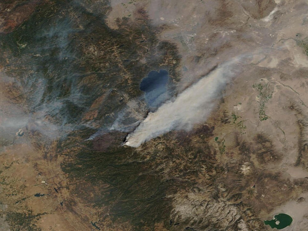 This Sunday, Aug. 29, 2021, image provided by Maxar Technologies, shows a Moderate Resolution Imaging Spectroradiometer (MODIS), a true-color image overview of the wildfires at Lake Tahoe, in South Lake Tahoe, Calif. Climate change has made the region warmer and drier in the past 30 years and will continue to make the weather more extreme and wildfires more destructive, according to scientists.